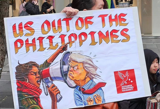 A "US out of the Philippines" warning to President Trump placard at the rally