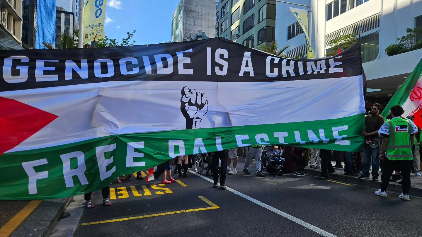 A "Genocide is a crime" banner at the Global March for Palestine