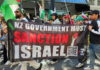 A banner at the Auckland "global day of action" march calling on the New Zealand government to sanction Israel