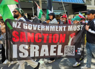 A banner at the Auckland "global day of action" march calling on the New Zealand government to sanction Israel