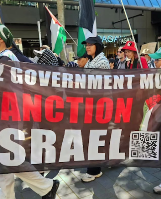A banner at the Auckland "global day of action" march calling on the New Zealand government to sanction Israel