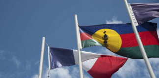 The French and Kanak flags flying high