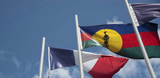 The French and Kanak flags flying high