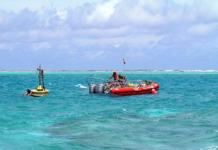 Oceanographers deploy a buoy inside the Rose Atoll in American Samoa waters