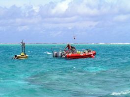 Oceanographers deploy a buoy inside the Rose Atoll in American Samoa waters