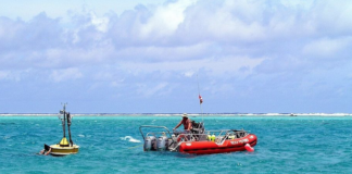 Oceanographers deploy a buoy inside the Rose Atoll in American Samoa waters