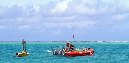 Oceanographers deploy a buoy inside the Rose Atoll in American Samoa waters