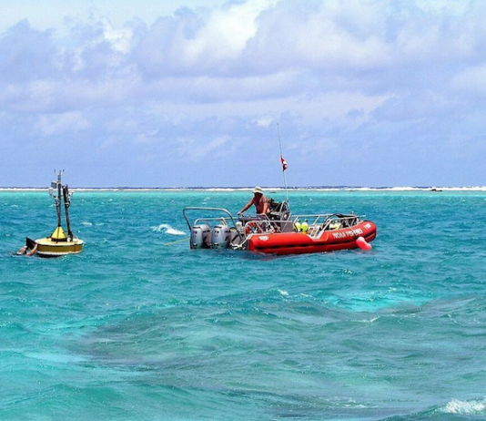 Oceanographers deploy a buoy inside the Rose Atoll in American Samoa waters