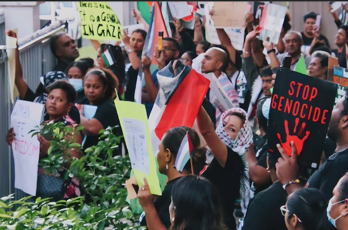 "Stop Genocide" says the placard held by Fijians for Palestine, one of the many solidarity groups around the Pacific